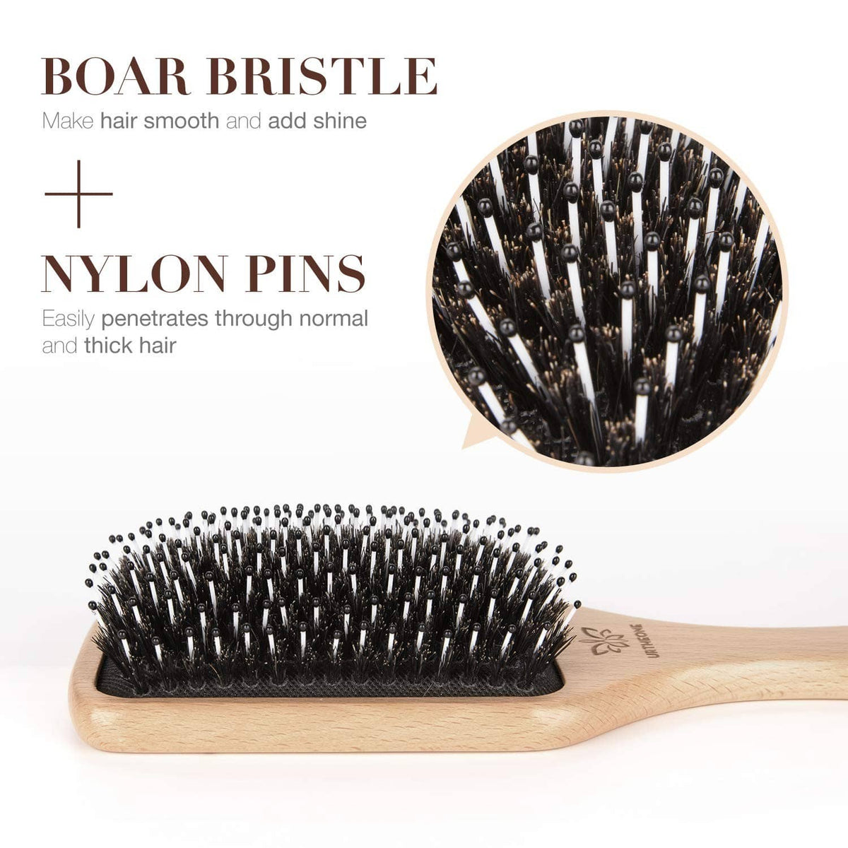 Boar bristle hair brush with natural wood paddle and black bristles, close-up
