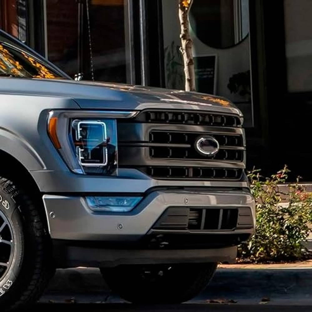 Black front lower center bumper grille on silver Ford F-150 front corner view