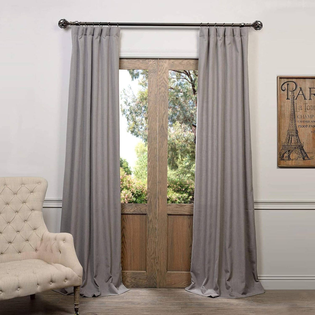 Curtain rod with two decorative finials and gray drapes, end cap detail