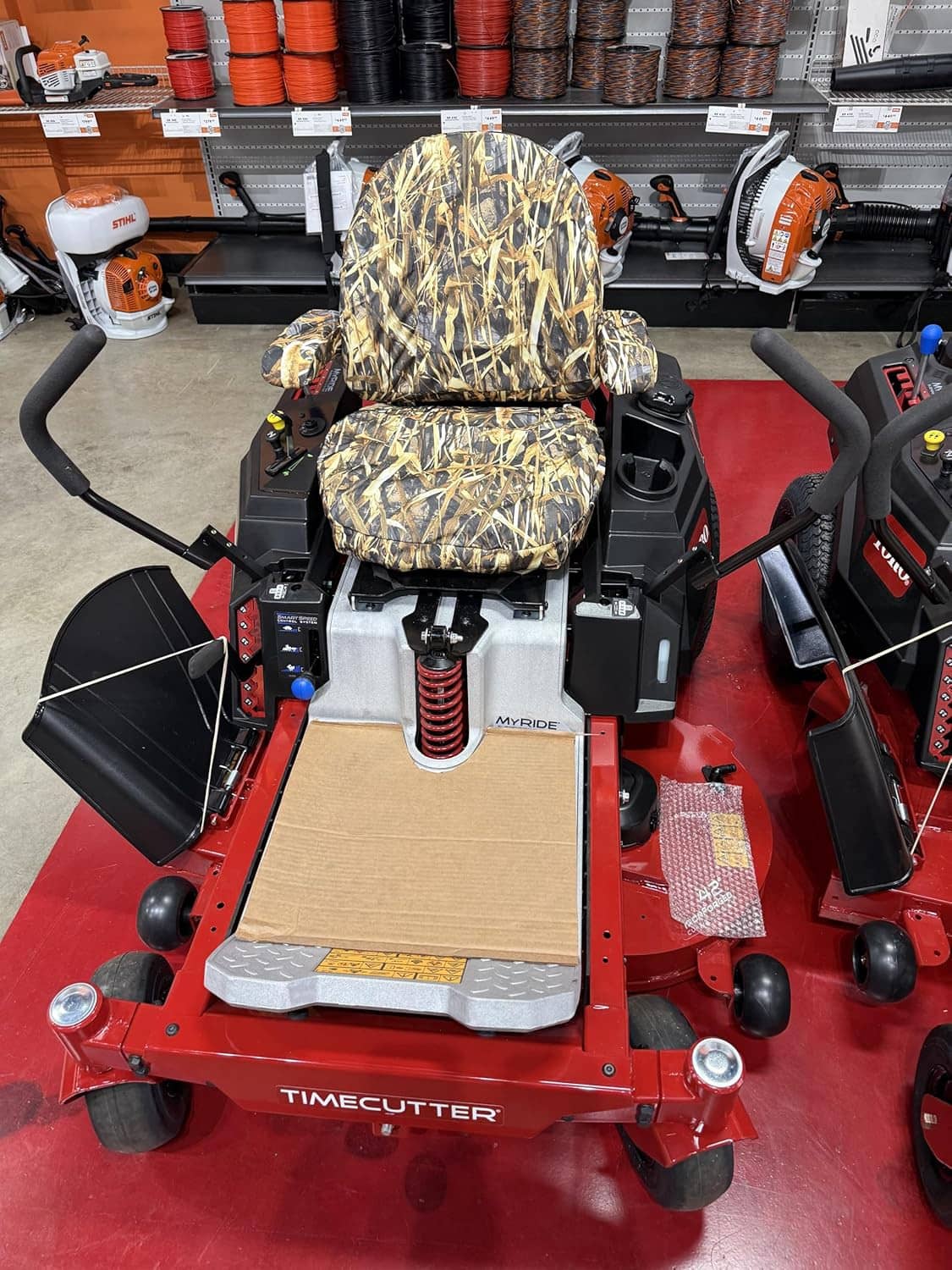 Camouflage seat and backrest covers on Timecutter zero-turn mower, same front angle
