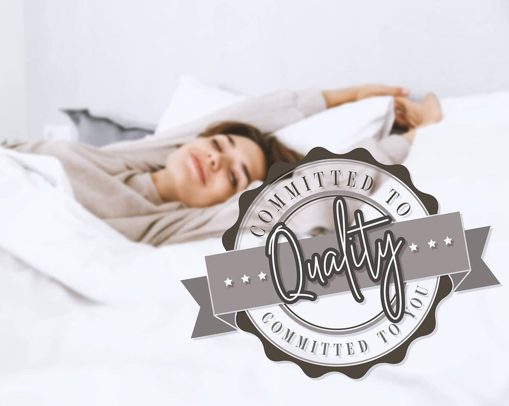 Comforter set on white bed, person lying under quilted blanket with quality badge