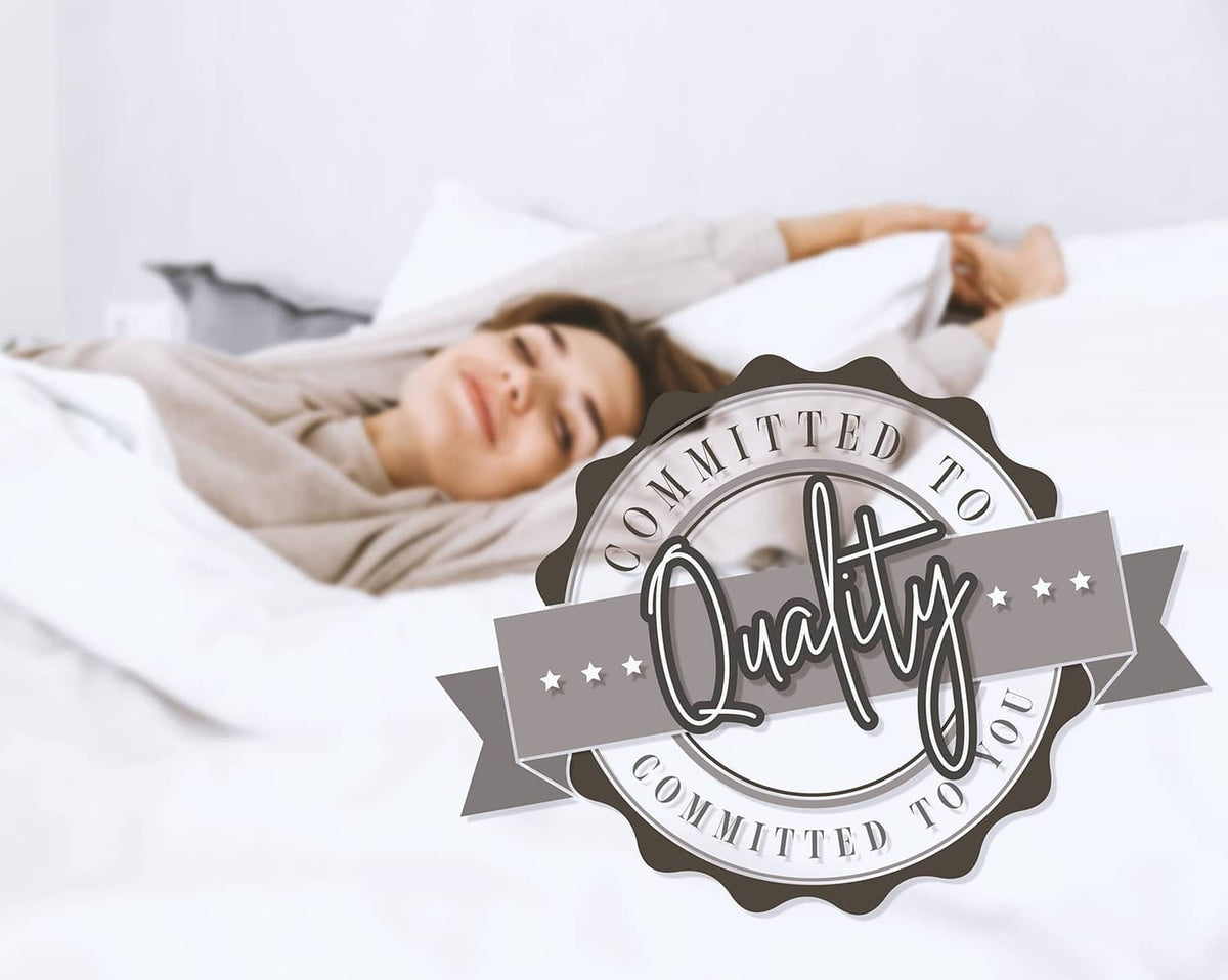 Comforter set on white bed, person lying under quilted blanket with quality badge