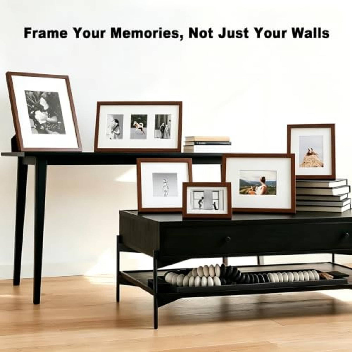 Group of brown wood picture frames with glass covers on a black console