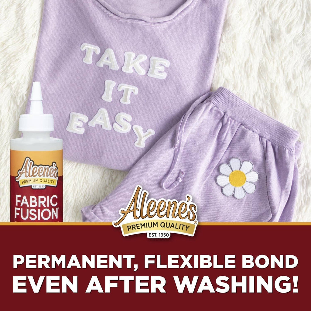 Purple fabric set with applique and Aleene's Fabric Fusion bottle graphic.