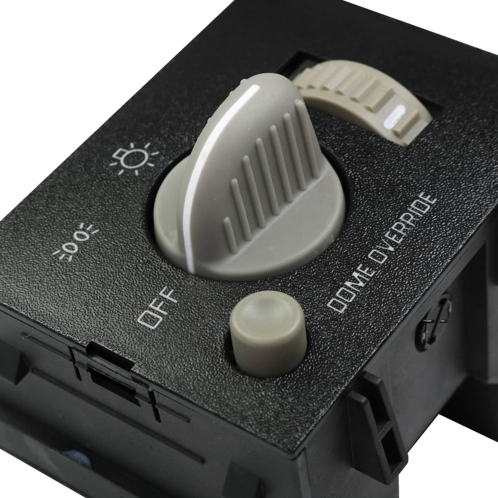 Black dash headlight switch close-up with white knob and OFF/parking markings