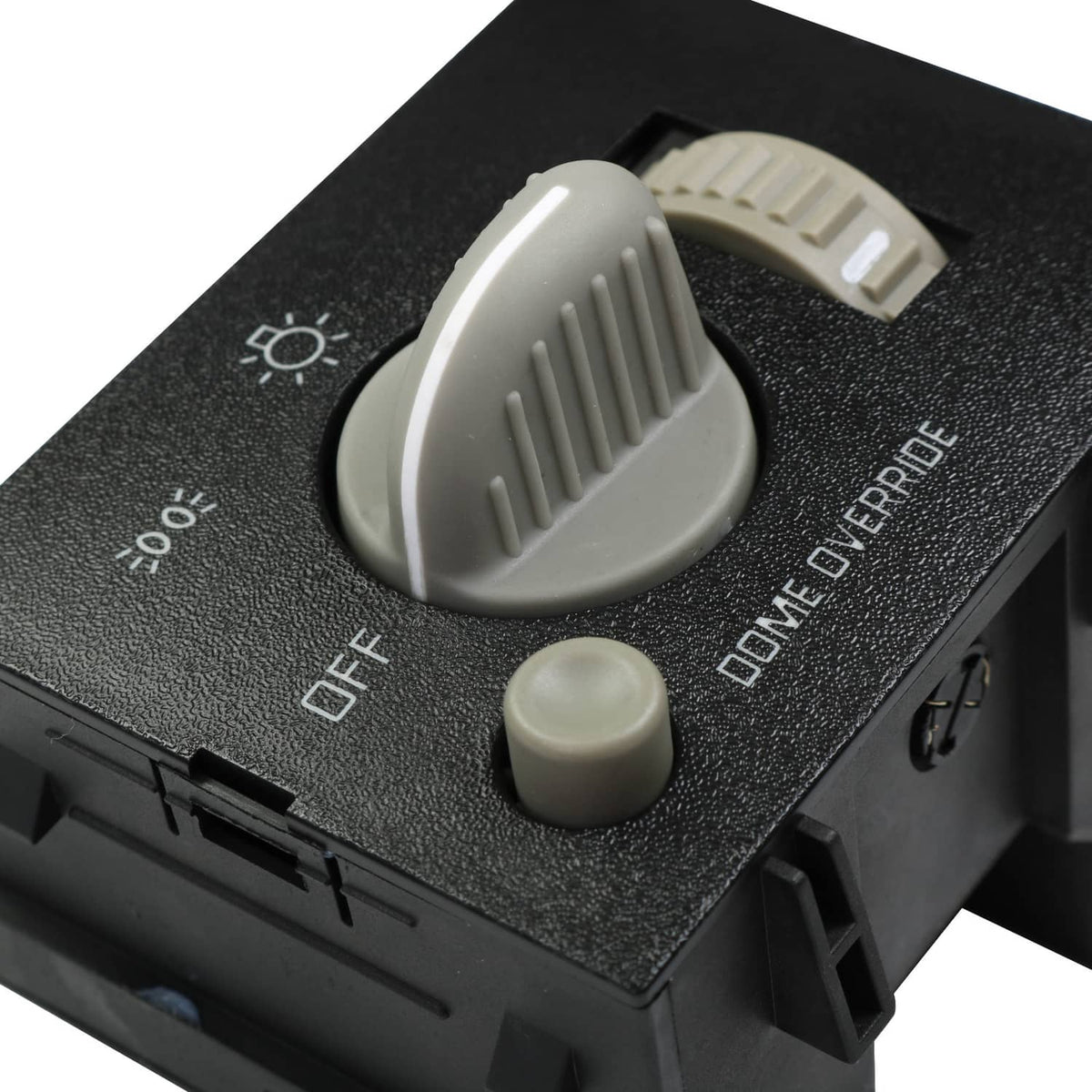 Black dash headlight switch close-up with white knob and OFF/parking markings