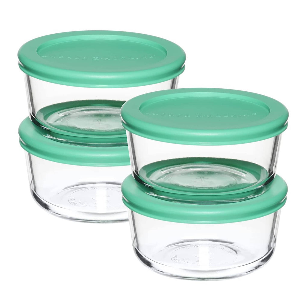 Stacked round glass storage containers with teal lids