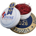 Red saffron threads in an open round tin with a sealed lid and loose strands