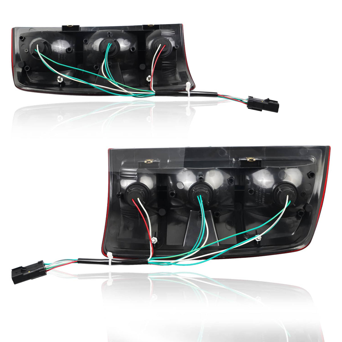 Pair of rear taillights with exposed wiring harness and back housings.