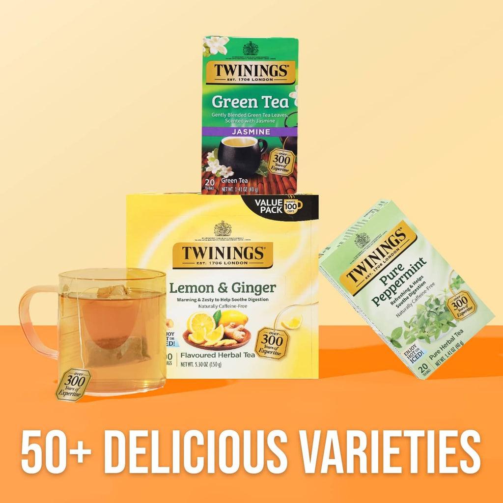 Twinings tea assortment with Lemon & Ginger and Pure Peppermint boxes and glass cup