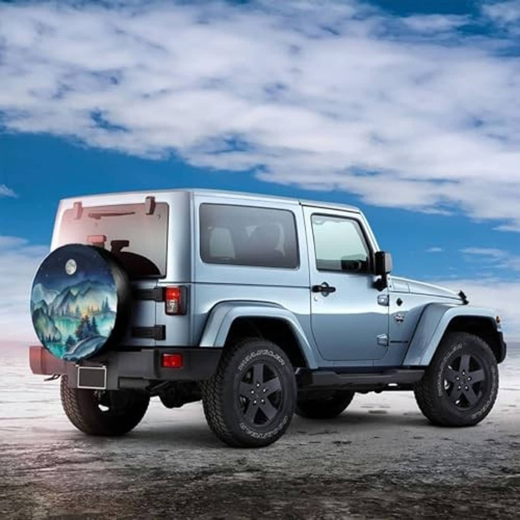 Spare tire cover on a white SUV rear, showing blue mountain night landscape and moon