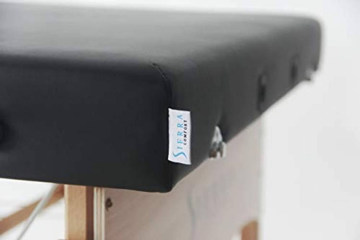 Black massage table pad with brand label on the side seam