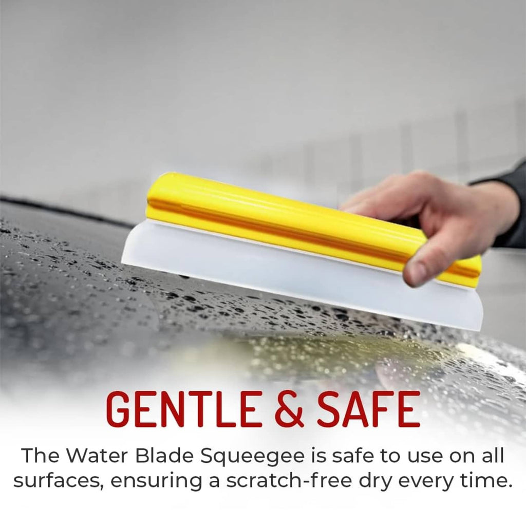 Hand holding yellow-and-white silicone squeegee to remove water from car surface
