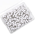 White map push pins with round heads in a clear plastic box