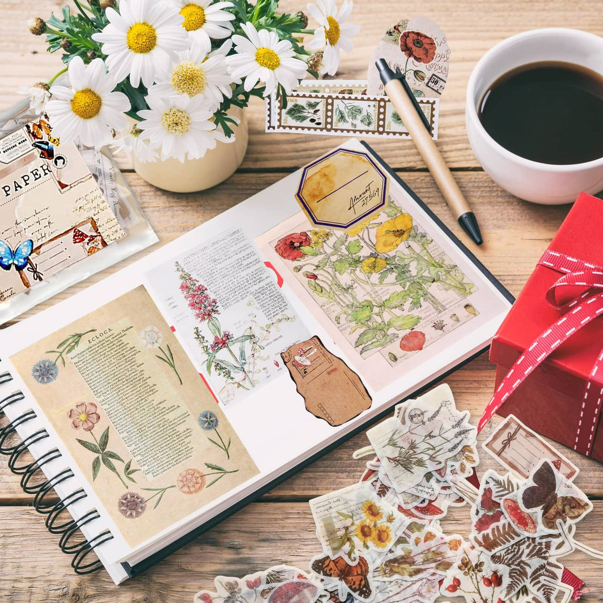 Junk journal craft stickers and printed papers on tabletop with flowers and butterfly accents