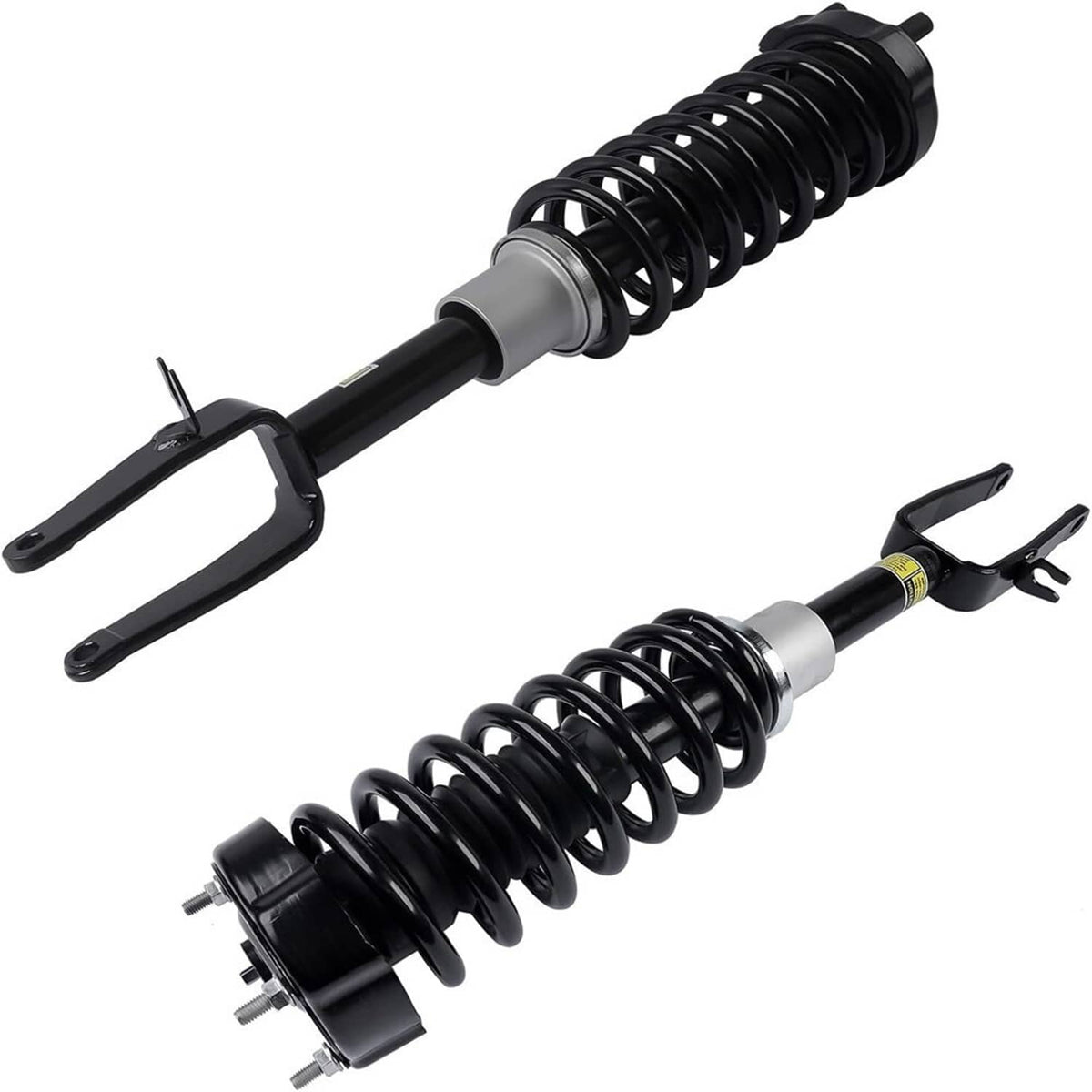 Shock strut assembly pair with black coil springs, silver sleeves, and mounting yokes