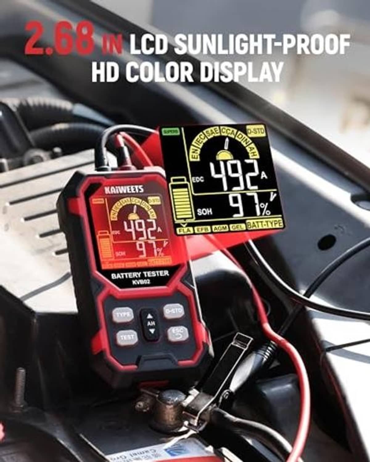 Car battery tester on engine bay with LCD screen displaying readings, red-and-black housing