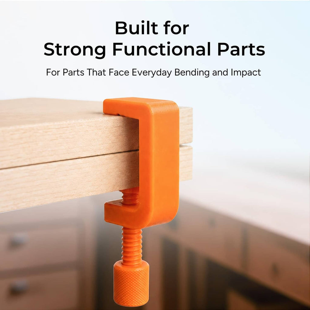 Orange 3D-printed clamp on a wooden board, held by threaded screw