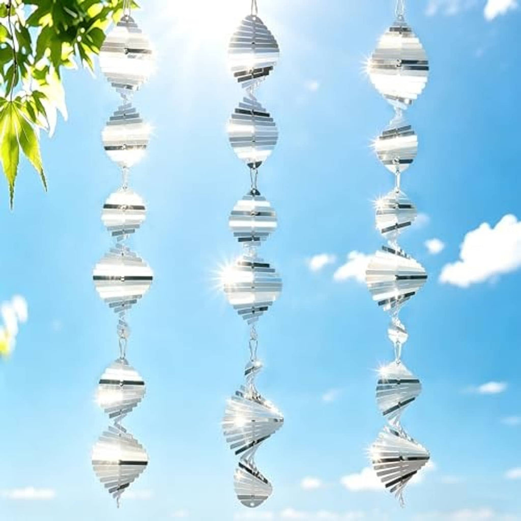 Set of silver wind spinners with spiral reflective discs and hanging chains