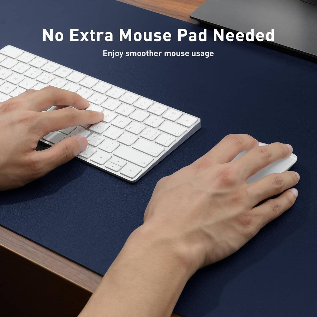 Dark blue desk pad protector with smooth surface, hands typing and using a mouse