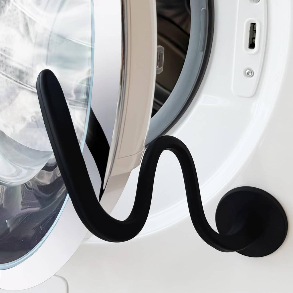 Black round-ended washer door prop holding the washer door ajar