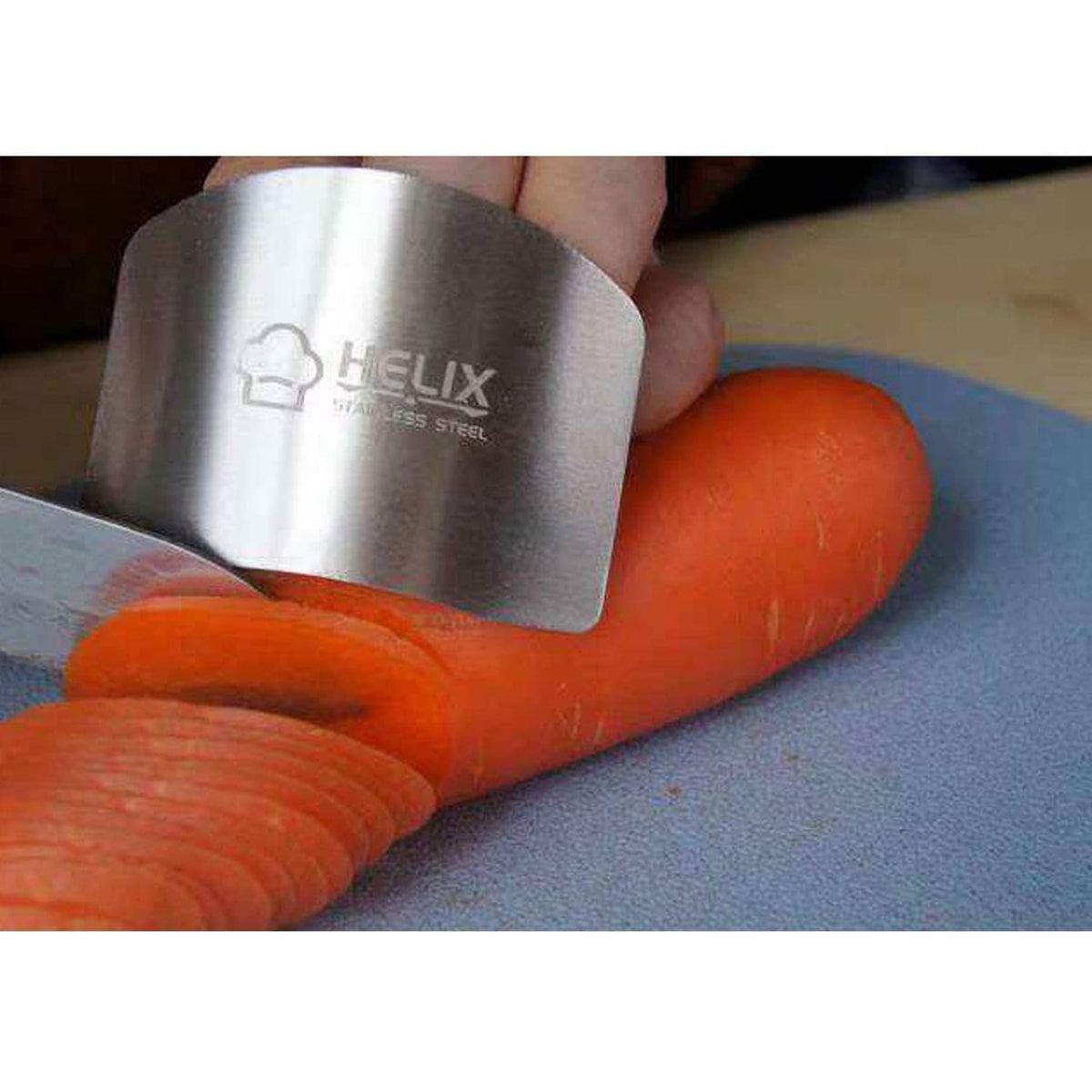 Stainless steel finger guard protector worn over orange-gloved fingers