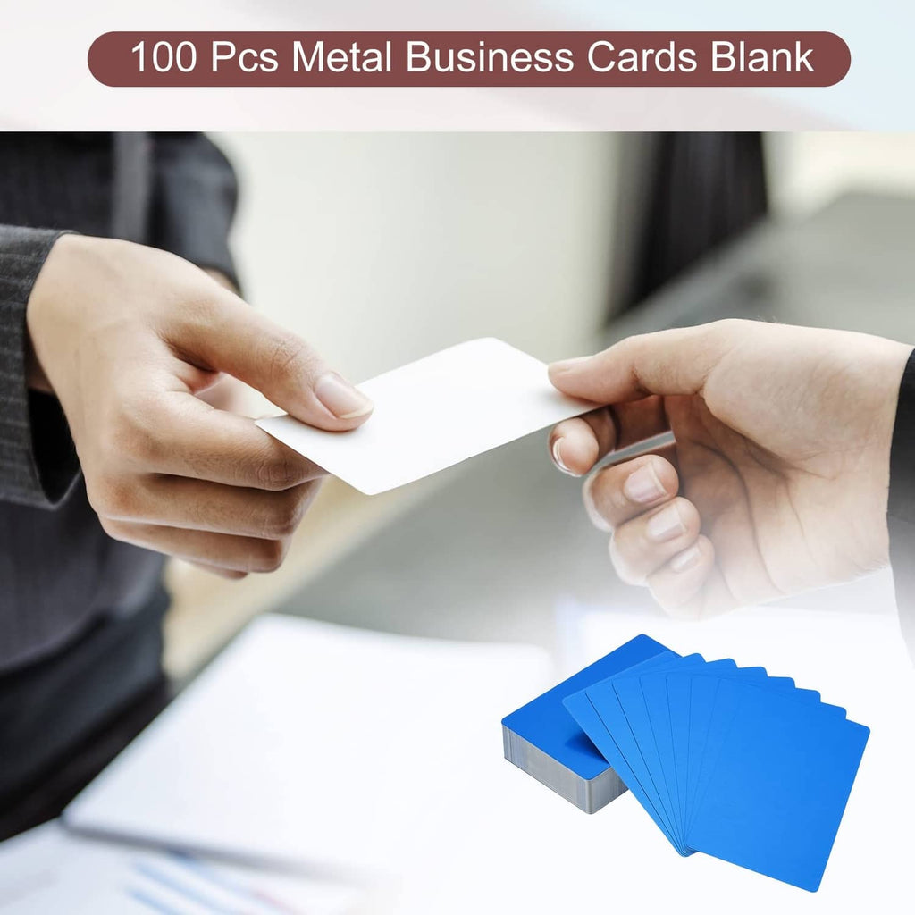 Blue metal business cards, blank stack with silver edges held by two hands.