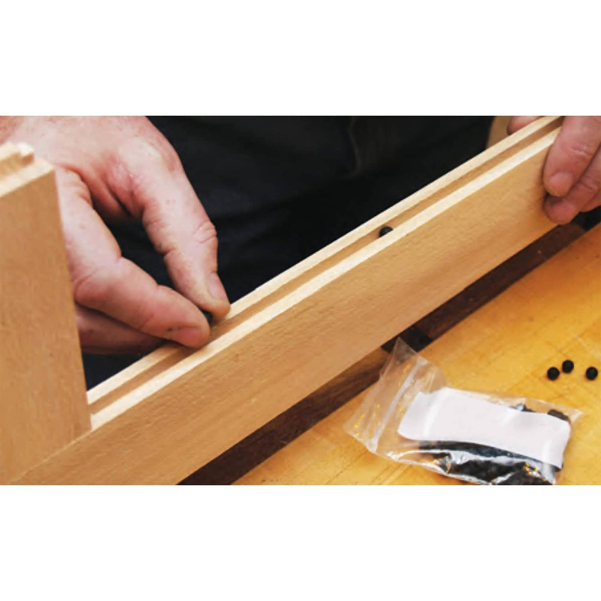 Black rubber ball door spacer pressed into cabinet rail groove