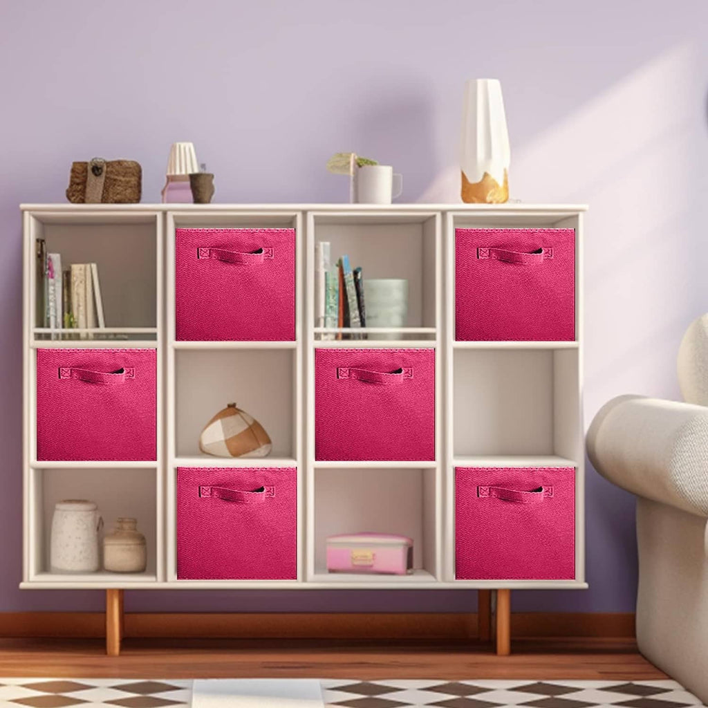 Fuchsia fabric storage cubes with front handles inside a white shelf unit