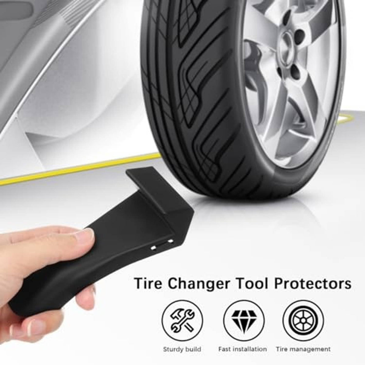 Black tire changer tool protector clamped near a wheel tire on a vehicle.