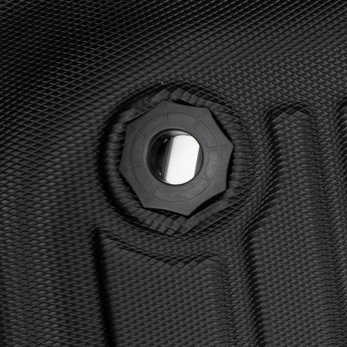 Close-up of black rubber floor mat with circular mounting hole and textured border