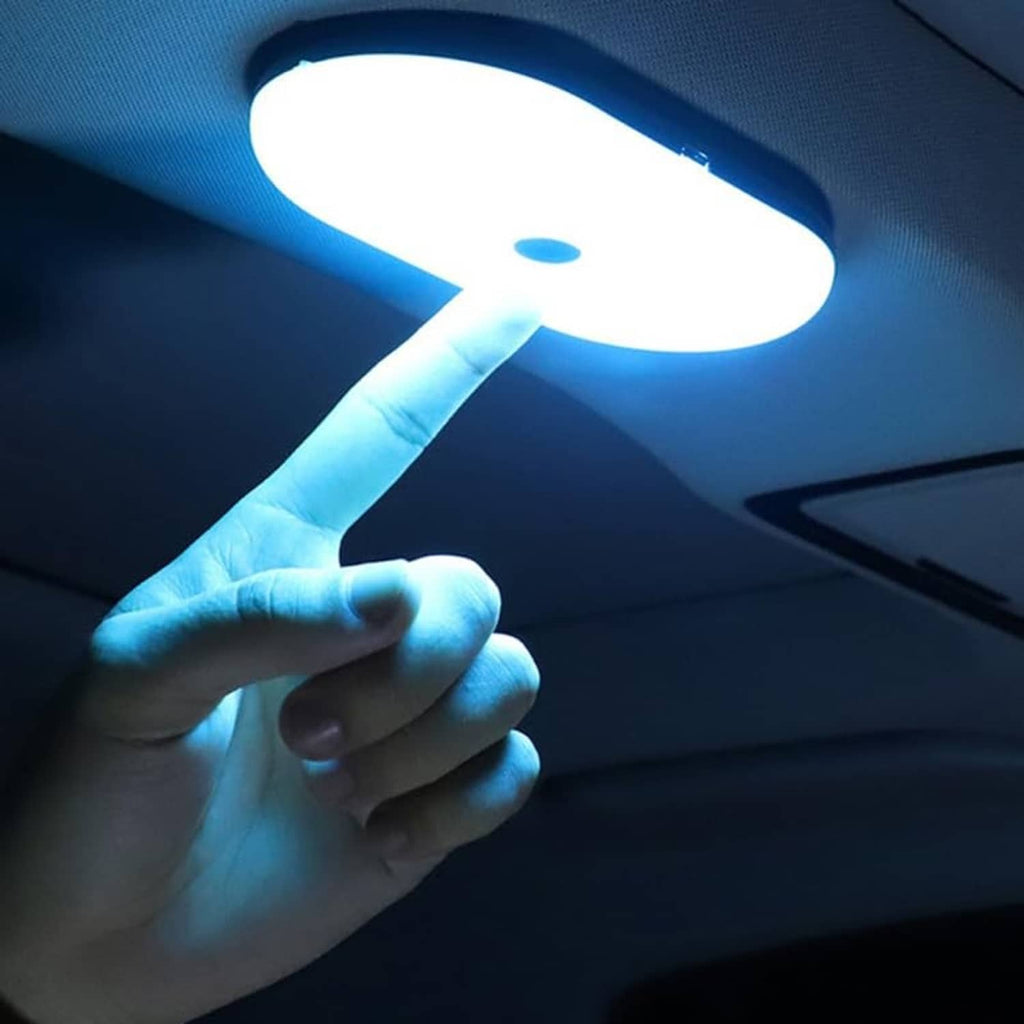 LED car dome lamp glowing with finger touching the center control button