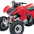 Red and black front air shock absorbers on an ATV, with coil springs and mounting bolts