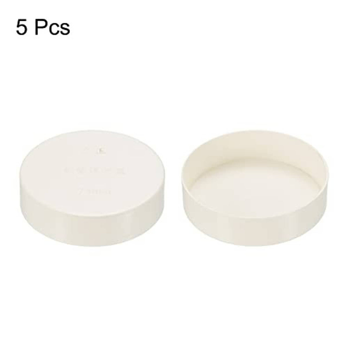 Two white PVC pipe end cap fittings, round tops with open cup interior