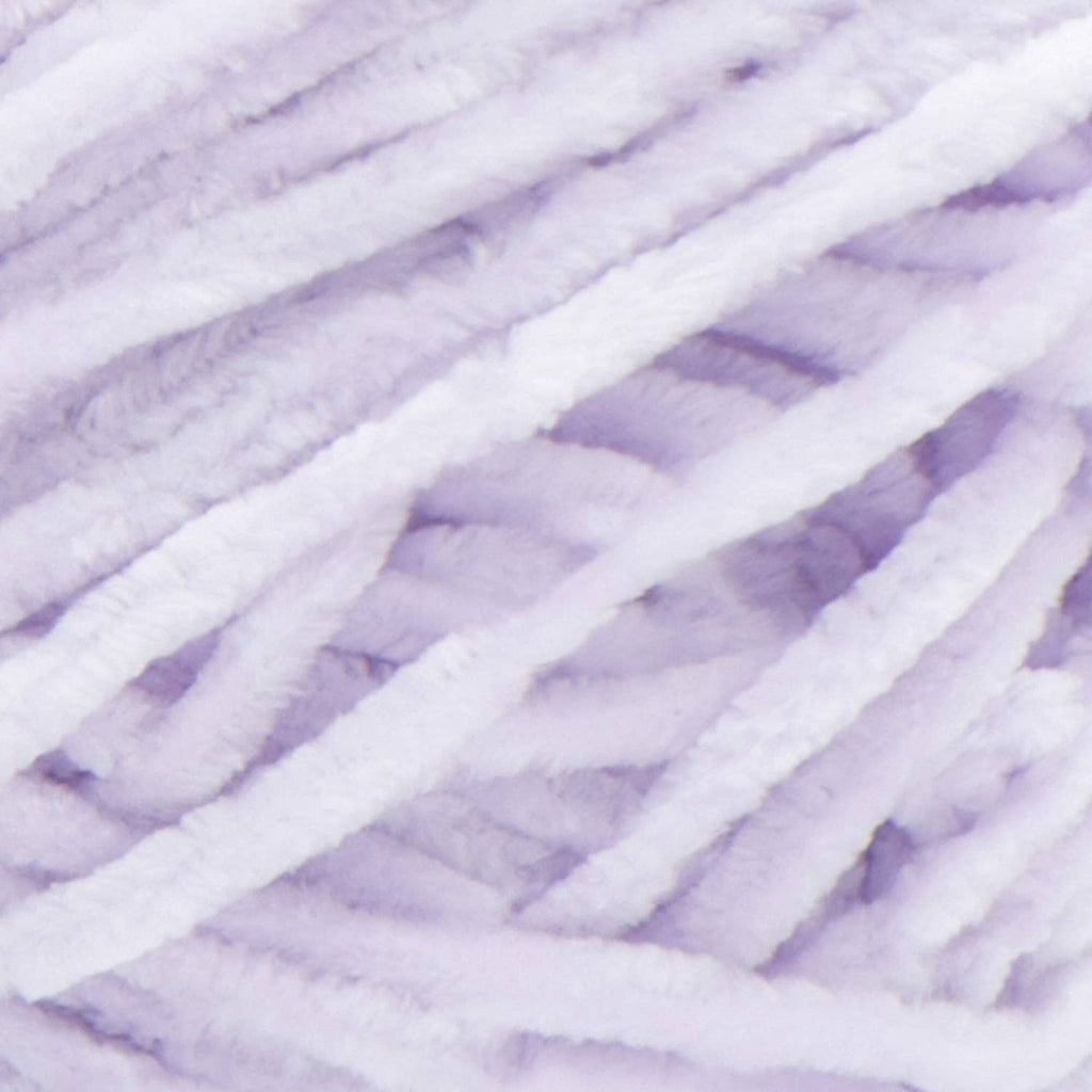 Close-up of lilac velvet yarn strands with soft, fuzzy texture