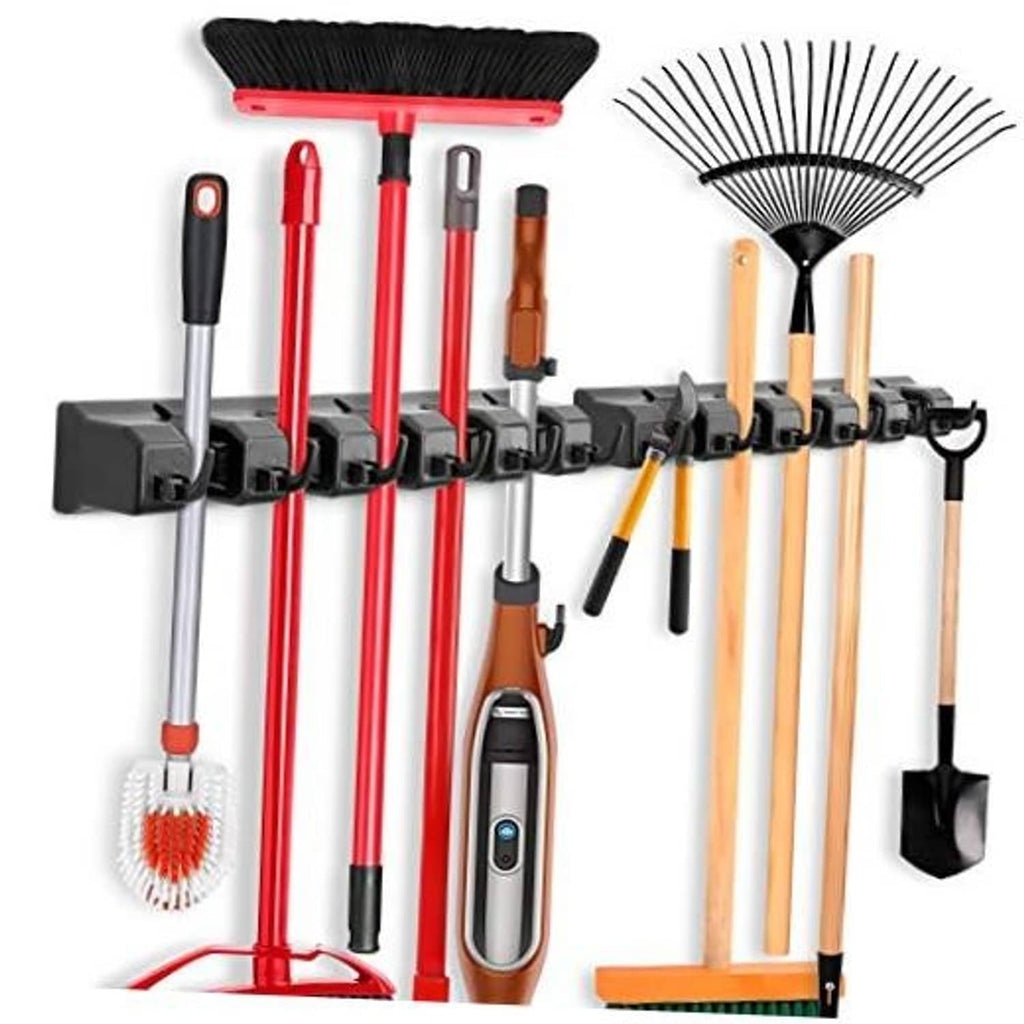 Wall-mounted mop and broom holder rack with hooks holding red and wood-handled tools
