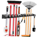 Wall-mounted mop and broom holder rack with hooks holding red and wood-handled tools