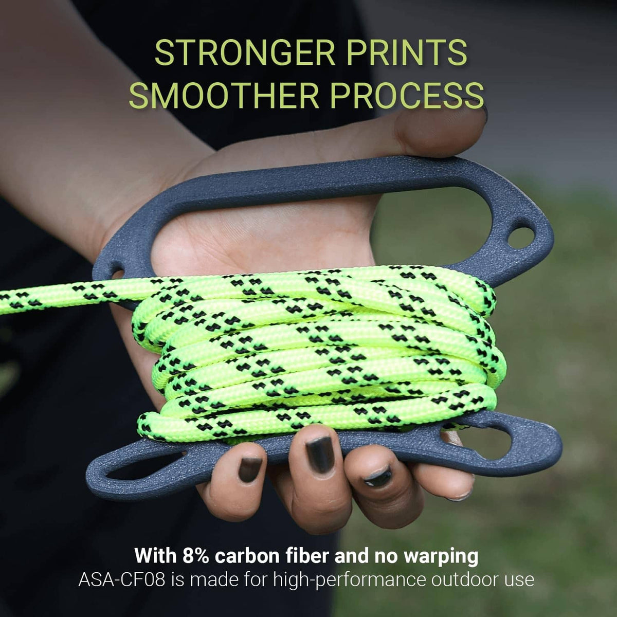 Green carbon-fiber reinforced 3D printing filament coil held with grey carry handles