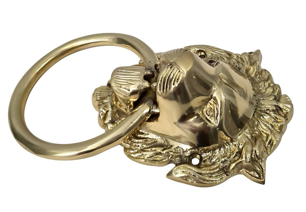 Brass lion door knocker with circular ring handle and embossed lion face in relief