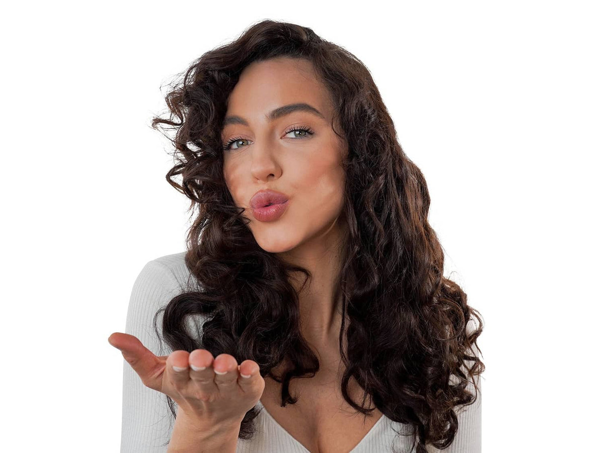 Woman with dark curly hair styled for heatless curls