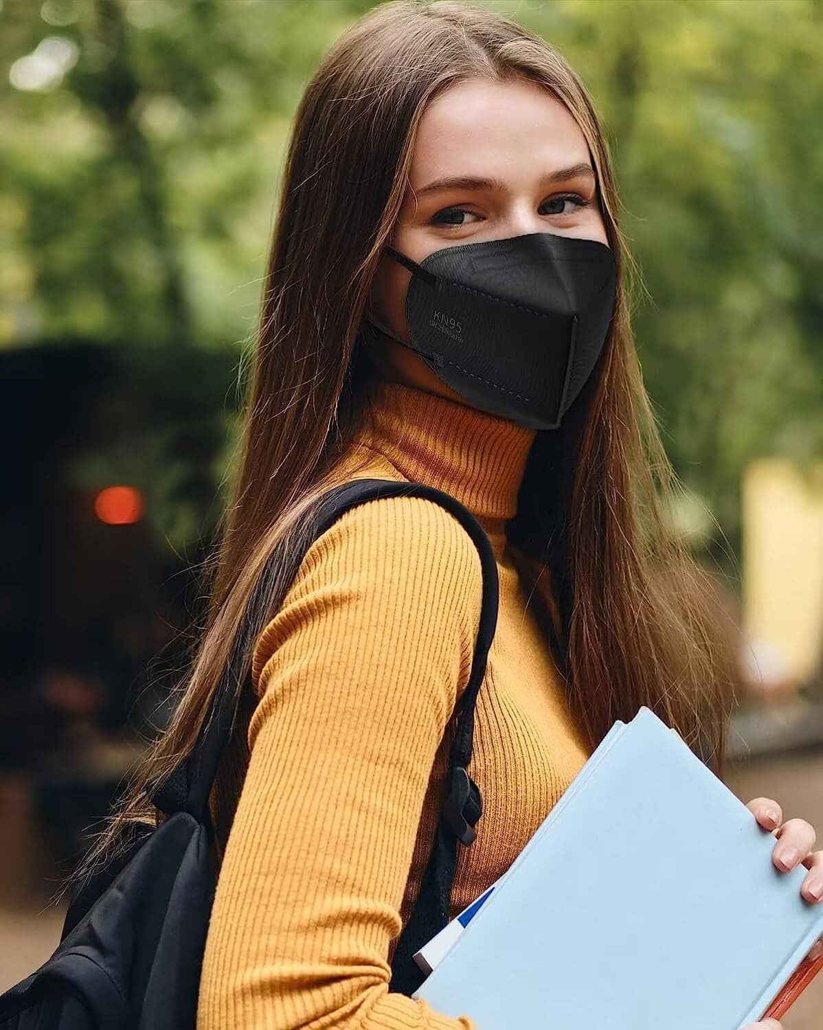 Black KN95 face mask worn on a person outdoors