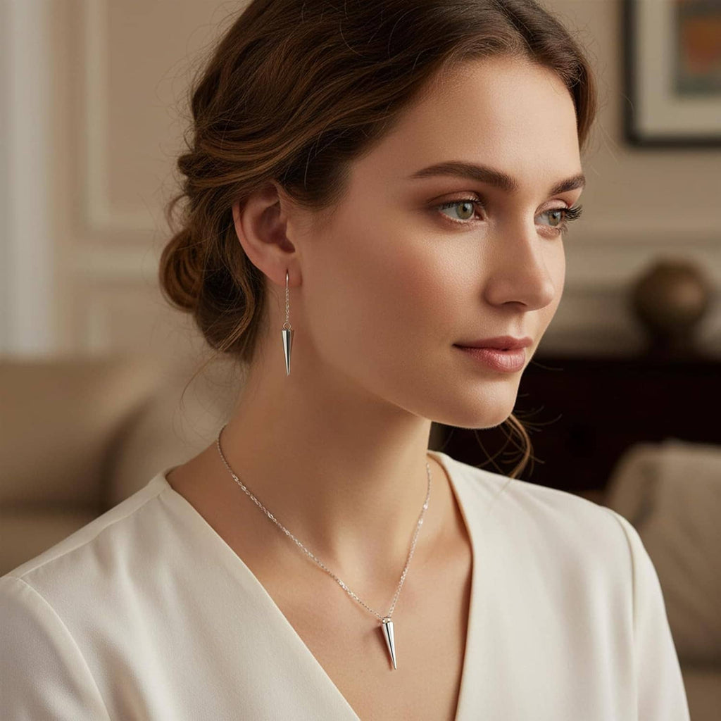 Woman wearing silver spike cone earrings and a matching spike cone pendant necklace