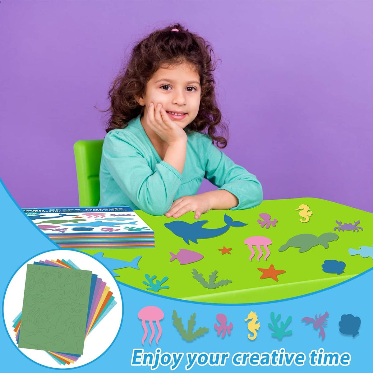 Smiling child with green craft paper covered in colorful sea animal cutouts