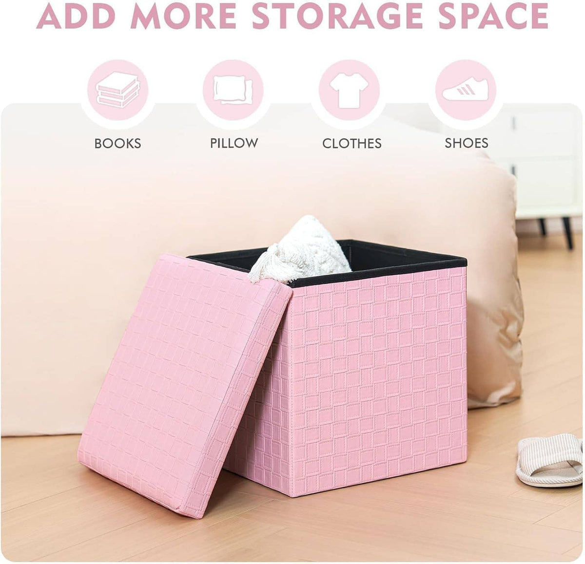 Pink storage ottoman with open lid on floor, holding folded towels and items.
