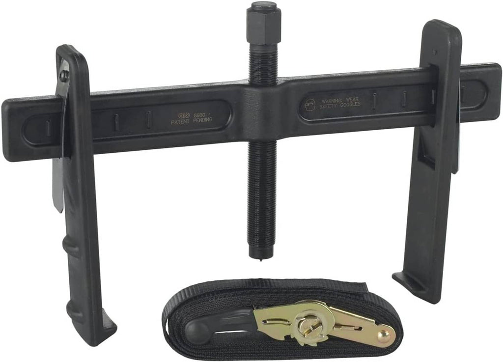 Brake drum and rotor puller tool with threaded screw and lifting arms, plus strap