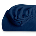 Dark blue fleece fitted sheet, rolled with visible elastic edge