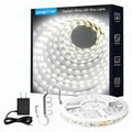 LED strip light kit with coiled white strip, controller, and power adapter