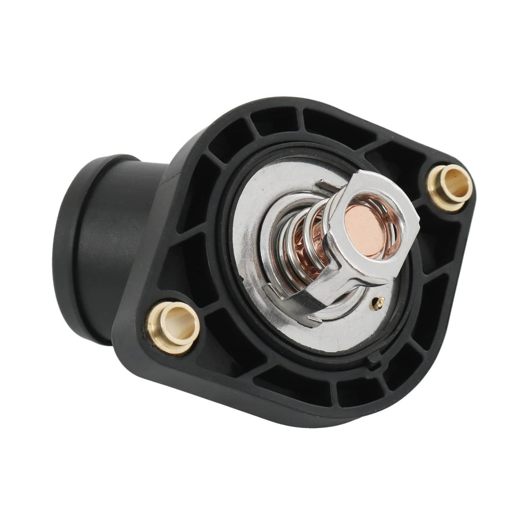 Close-up black thermostat housing with circular metal valve, coil spring, and brass studs