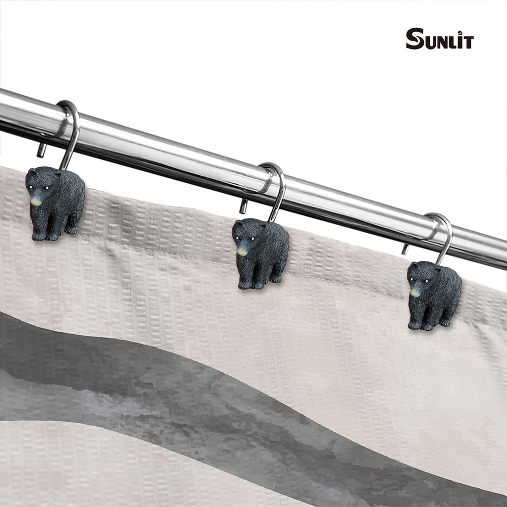 Black bear shower curtain hooks on chrome rod, three clips attached