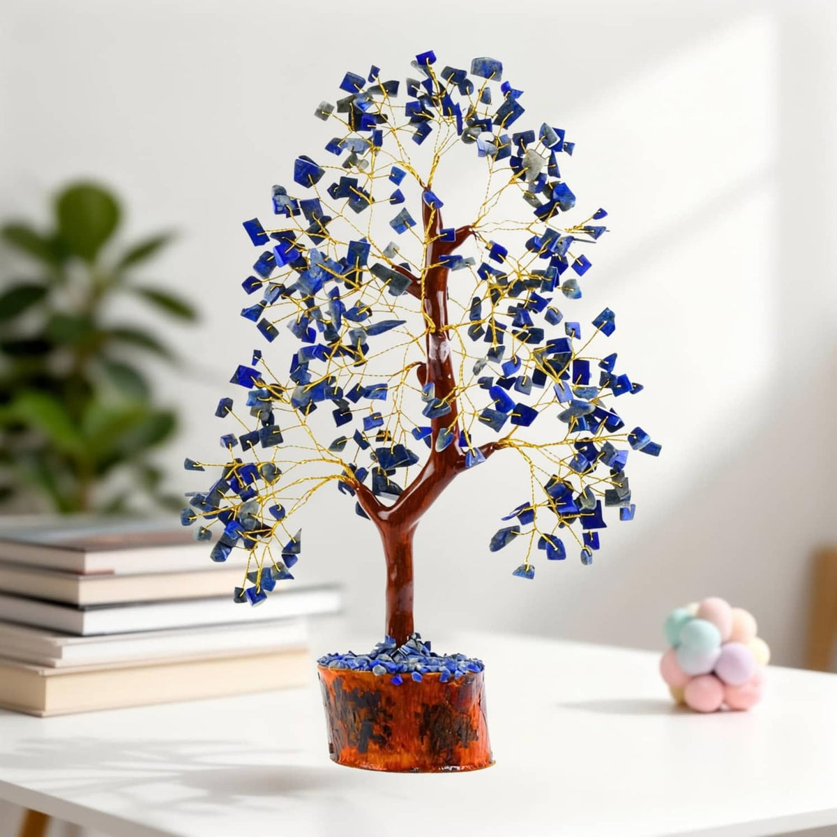 Lapis lazuli crystal tree with golden wire branches and amber wooden base, front view close